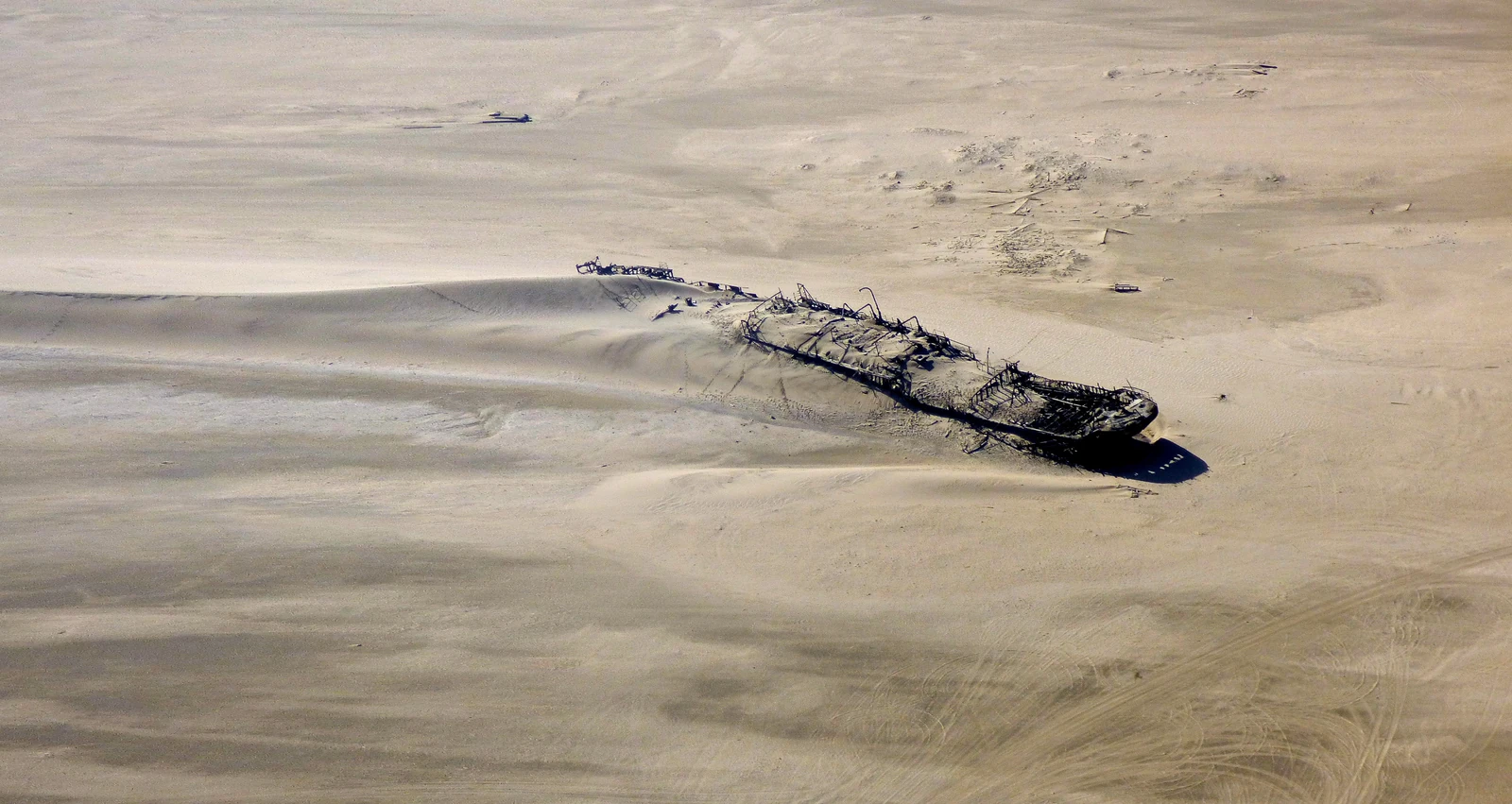 The Eduard Bohlen shipwreck lying in the sand on Namibia’s Skeleton Coast, photographed from the air