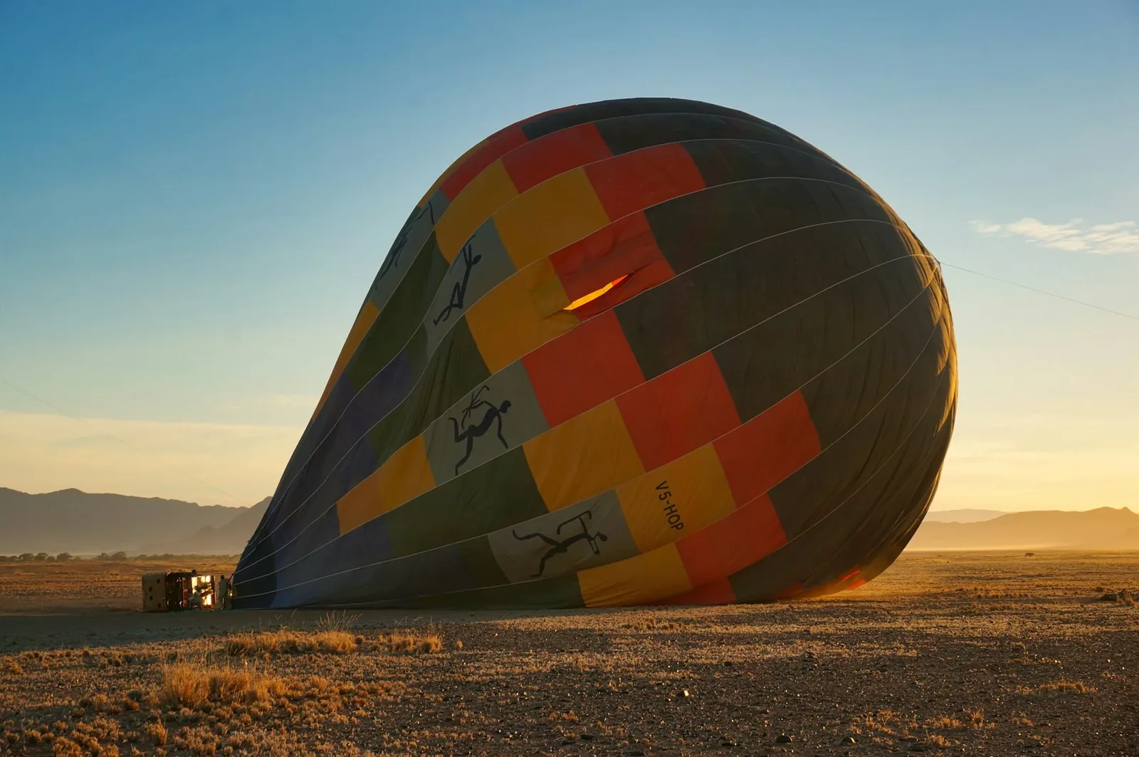 A hot-air balloon being prepared on the desert plain at Sossusvlei
